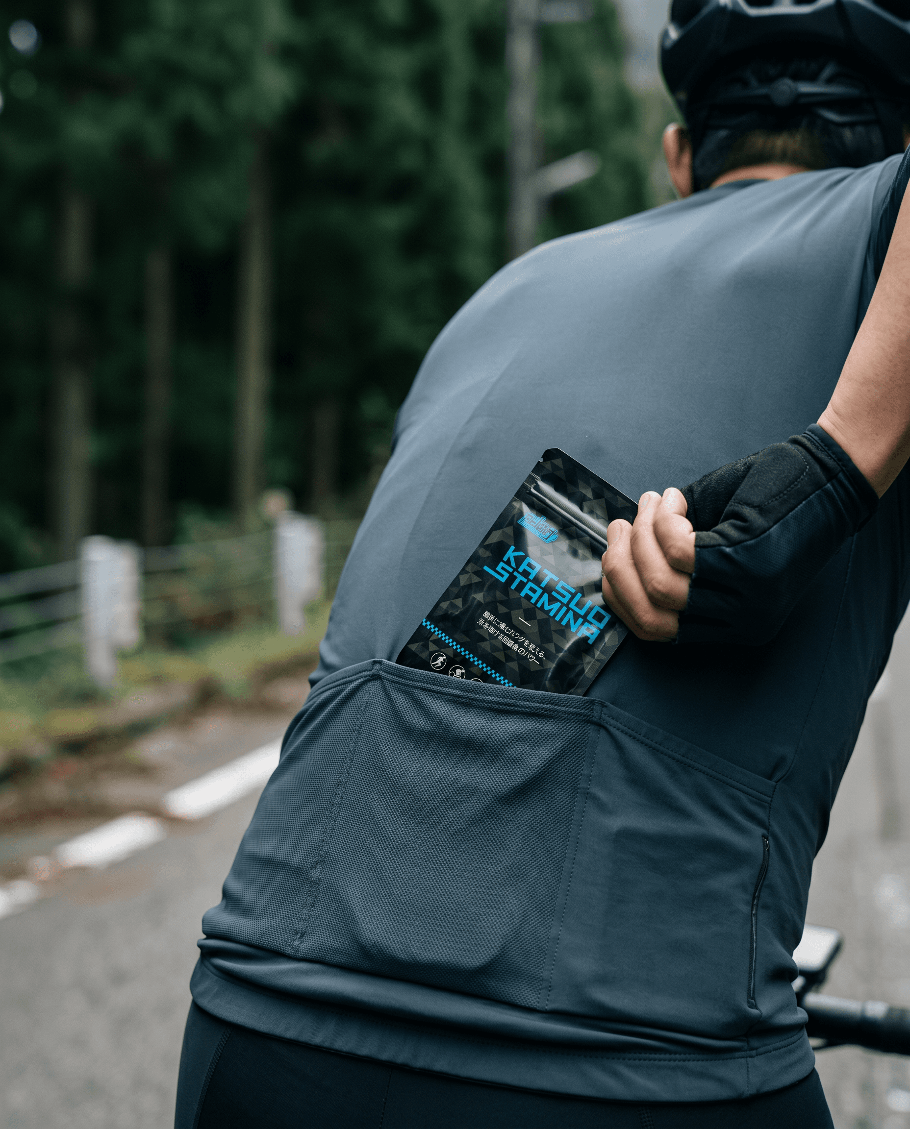 Cyclist mid-effort, hand on the hoods